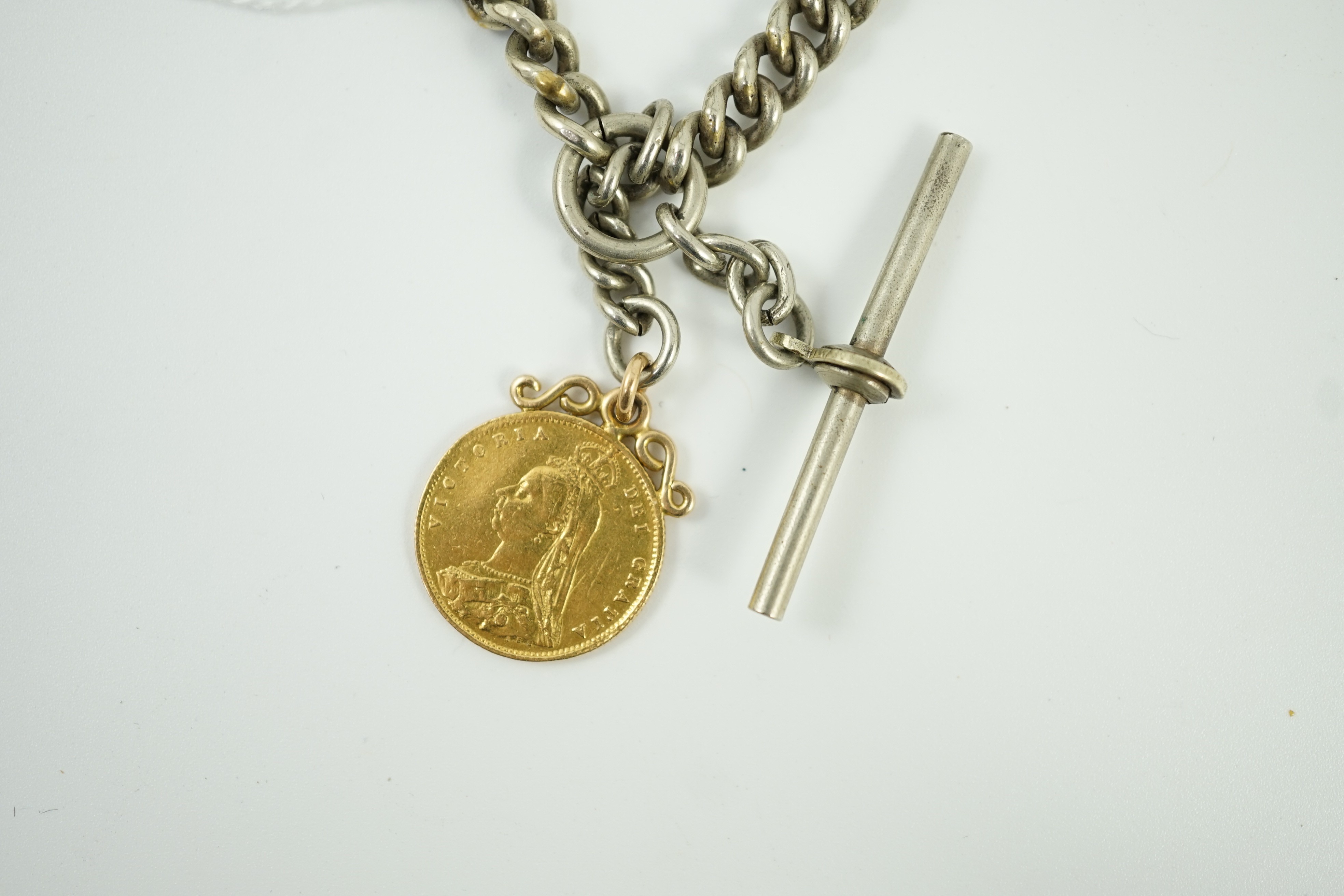 A Victorian 1887 gold half sovereign, on pendant mount and hung from a white metal albert.